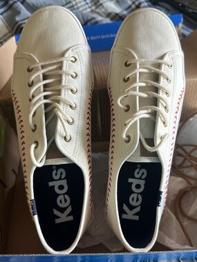 Keds “Kickstart Pennant” Cream Canvas Lace-Up Sneakers with Red Stitch Detail
